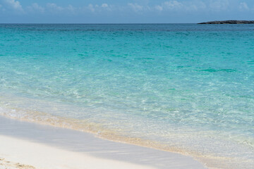 Tropical beach with white sand and blue water in Paradise Island, Bahamas