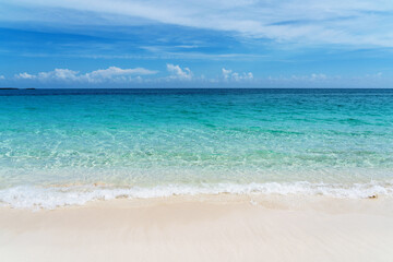 Tropical beach with white sand and blue water in Paradise Island, Bahamas