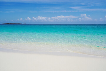 Tropical beach with white sand and blue water in Paradise Island, Bahamas