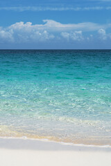 Tropical beach with white sand and blue water in Paradise Island, Bahamas