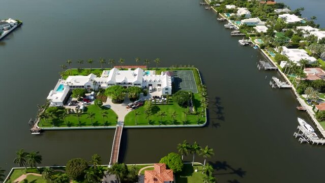 Aerial lateral flyby 10 Tarpon Isle luxury waterfront mansion in Palm Beach currently listed for sale for 218 million usd