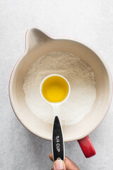 Vegetable oil in a measuring cup, vegetable oil for baking, process of making a cupcake