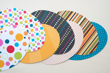 overlapping whimsical ovoid shapes cut from scrapbook paper using a machine