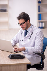 Young male doctor in telemedicine concept