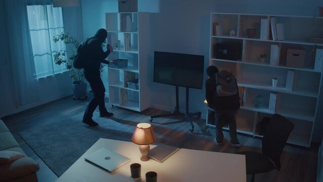 The Alarm System Scared Off Two Robbers in Black Clothes and Masks with a Flashlight Broke Into House. Intrusion Alarm. Security Systems Integration. AI-based Security