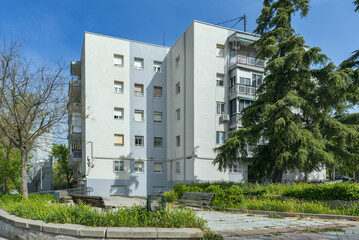 Simple facade of a residential housing building surrounded