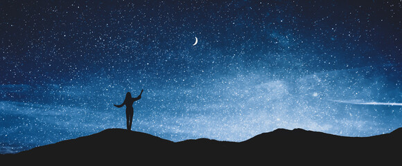Silhouette of woman in mountains under starry sky at night, space for text. Banner design