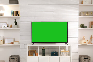 Chroma key compositing. TV with mockup green screen in room. Mockup for design