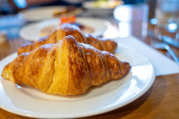 Two fresh baked puff croissants, traditional French breakfast