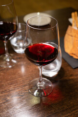 Dinner with glass of dry red wine in Italian osteria restaurant