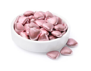 Bowl and delicious heart shaped candies on white background