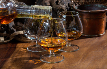 Tasting of aged french cognac brandy alcoholic drink in old cellars of cognac-producing regions...