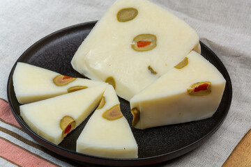 Cheese collection, fresh Italian pecorino cheese made from sheep milk filled with green olives...