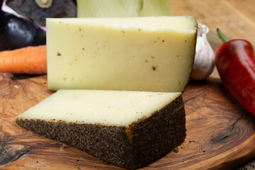 Cheese collection, aged hard Italian sheep cheese black pecorino from Sicily island or pecorino nero di Sicilia