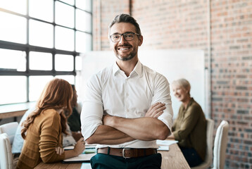 Portrait, smile and man with startup, arms crossed and teamwork with confidence, workplace and happiness. Face, male CEO and leader in a workshop, meeting and collaboration for brainstorming