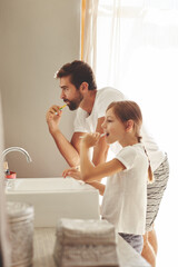 Brushing teeth, dad and young child in a bathroom at home in morning with dental cleaning. Oral hygiene, kids and father together in a house with bonding and parent love for children with toothbrush