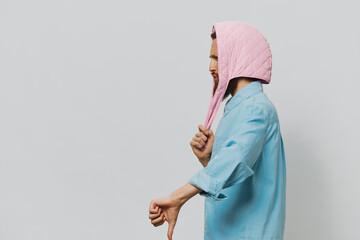 Funny man in a pink hat portrait on a light gray background. Smile and positive emotions.