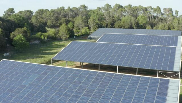 Aerial shot that reveals a small solar panel farm in the forest