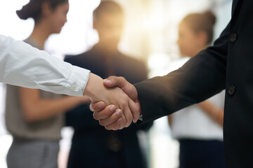 Handshake, business people and partnership deal at meeting for networking, b2b and success. Professional man and woman shaking hands as corporate partner for introduction, contract agreement or trust