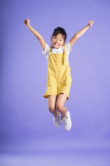 cute asian baby girl posing on purple background