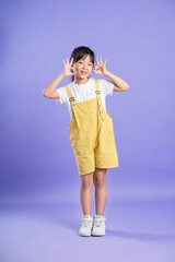 cute asian baby girl posing on purple background