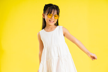 happy smiling asian baby girl on yellow background