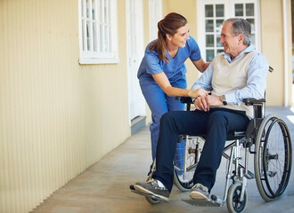 Talking, happy caregiver or old man in wheelchair in hospital helping an elderly patient for...