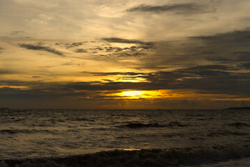 The sky with the orange light of the evening sun that is to sunset on the beach looks beautiful.