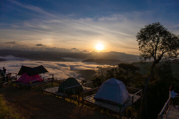 Beautiful nature scenic sunrise foggy landscape Camping and tent on top view mountain outdoor vacation, Tourism destination.