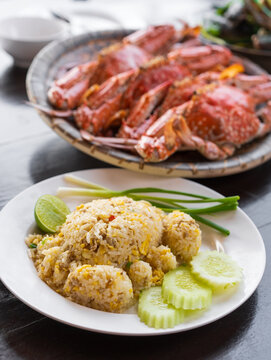 crab-shaped pork fried rice with cucumber spring onion lemon and steamed blue or baked horse crab in dish on table for fresh seafood set to lunch and dinner with iodine cholesterol food at restaurant