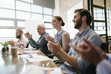 Meeting, success and applause with a business team in the boardroom in celebration of a target or goal. Collaboration, teamwork and support with a group of employee colleagues clapping in the office
