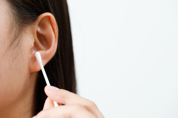 close up female cleaning ear using cotton stick for Healthcare.
