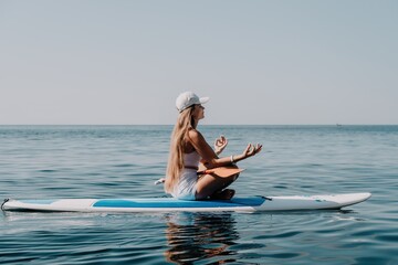 Woman sea sup. Close up portrait of happy young caucasian woman with long hair looking at camera and smiling. Cute woman portrait in bikini posing on sup board in the sea