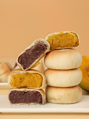 Cake made with purple sweet potato and pumpkin, moon cake, traditional Chinese pastry