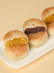 Cake made with purple sweet potato and pumpkin, moon cake, traditional Chinese pastry