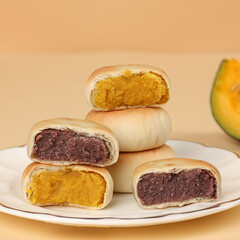 Cake made with purple sweet potato and pumpkin, moon cake, traditional Chinese pastry