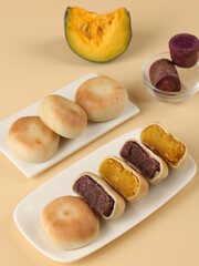 Cake made with purple sweet potato and pumpkin, moon cake, traditional Chinese pastry