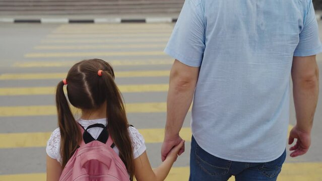 asphalt zebra crossing, school road, student happy family road, green light, father hand girl pedestrian, childhood dream concept, parents cheerful children, child road school, girl runs school road