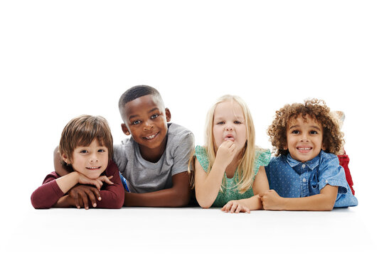 Smile, diversity and children or face on the floor together or against a white background and friends hug. Smile, kids and playful or laughing and isolated in studio or excited buddies and embrace