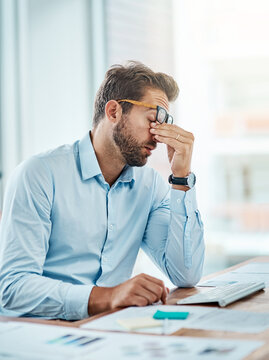 Business man, headache and sick, tired or fatigue in office while working on pc. Burnout, migraine and male person with depression, vertigo or brain fog, anxiety or mental health, stress or problem.