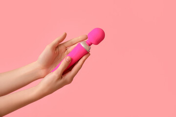 Woman with vibrator from sex shop on pink background