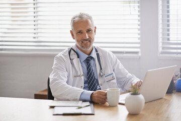 Healthcare, laptop and portrait of male doctor in his office analyzing online test results in a hospital. Happy, smile and professional mature man or medical worker working on a computer in a clinic