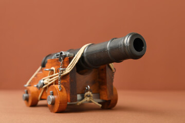 Toy model of cannon on brown background