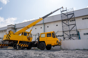 A mobile crane at roof repair in construction site.  Mobile Crane.