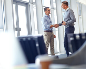 Business people, handshake and greeting in modern office, company lobby or airport lounge for...