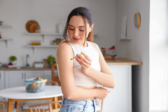 Young diabetic woman giving herself insulin injection at home