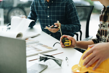 Engineers, designers and interior designers are finalizing the design of interiors by discussing selecting materials and colors to design rooms to present to clients.