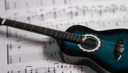 a classical guitar above the Notes of a new song