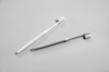 Plastic toothbrushes on grey background