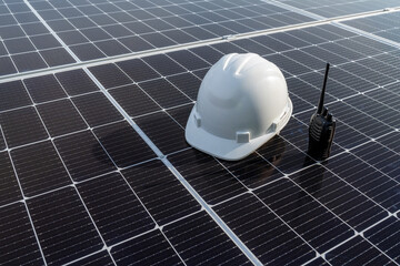 White helmet of engineer and radio communication on the solar panel on solar energy storage in the...